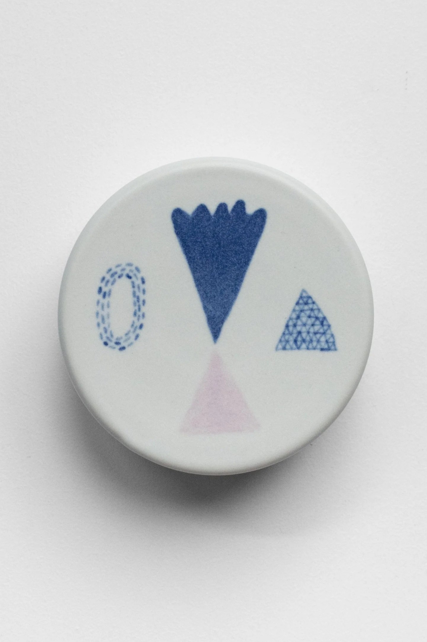 Hand-painted, ceramic, wall hanging sculpture with blue and lilac underglaze over creamy white porcelain.