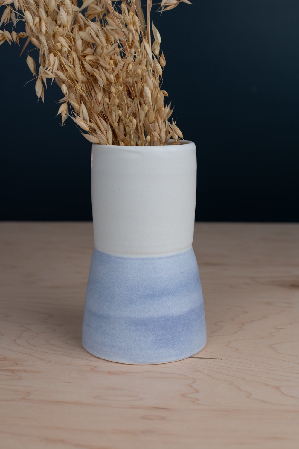 Hand-painted vase with lavender underglaze over creamy white porcelain.