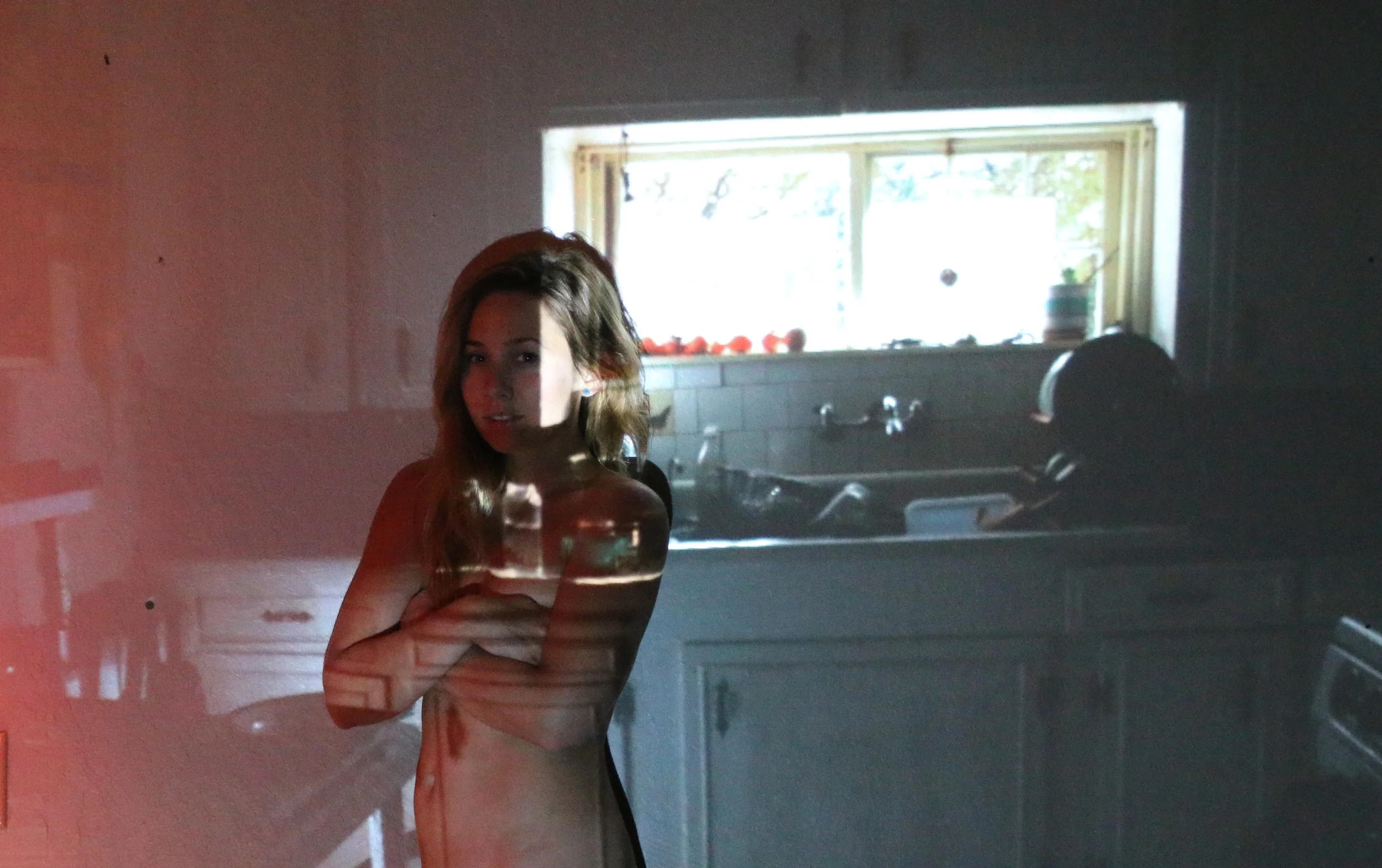  I projected old photographs on the wall and rephotographed them with my current self in the memory.  My first kitchen when I moved to California.  Here, I washed so many dishes, made so much coffee, at least twenty pies,&nbsp;and cried so many tears