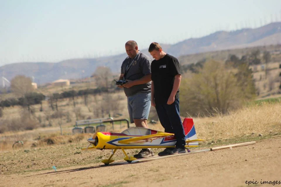 Father & Son demonstrate excellent flying skills before an audience of enthusiastic learners.