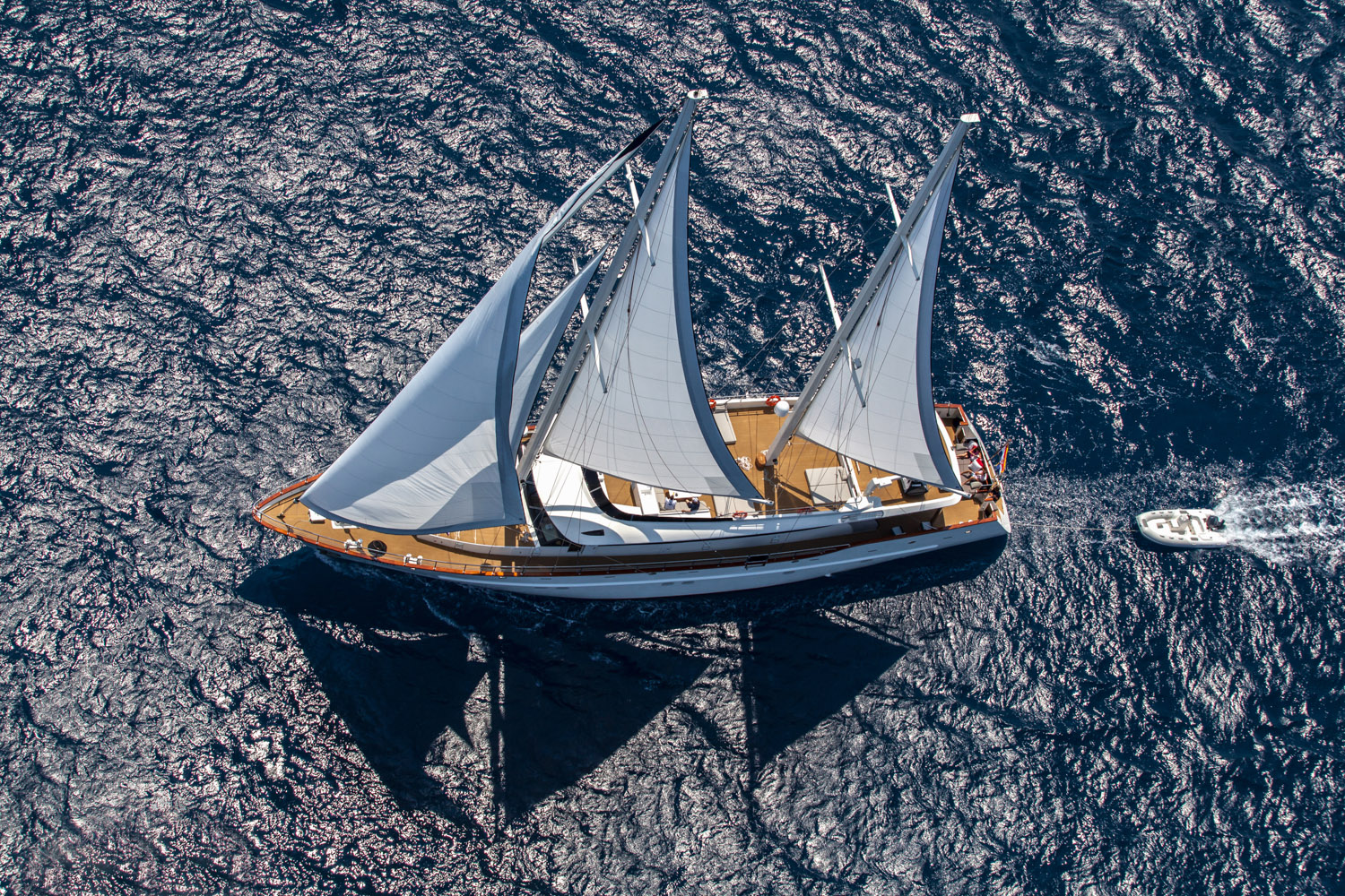 cruising yacht with sails and shade sails at sea.jpg