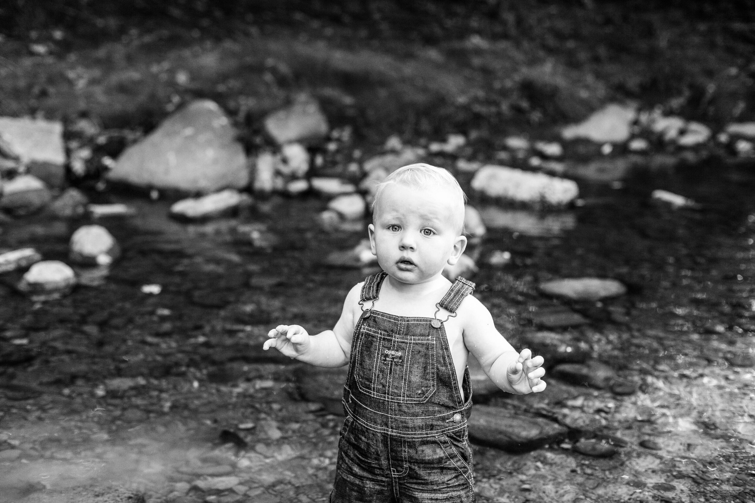  Baby photos in a creek wearing overalls 