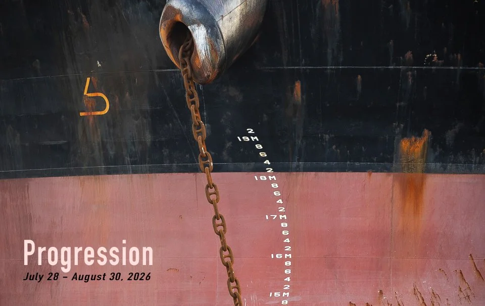 Close-up of the hull of a ship showing draft marks from 8 to 19 meters, with a rusted chain hanging down. Photograph by Eric Johnson.