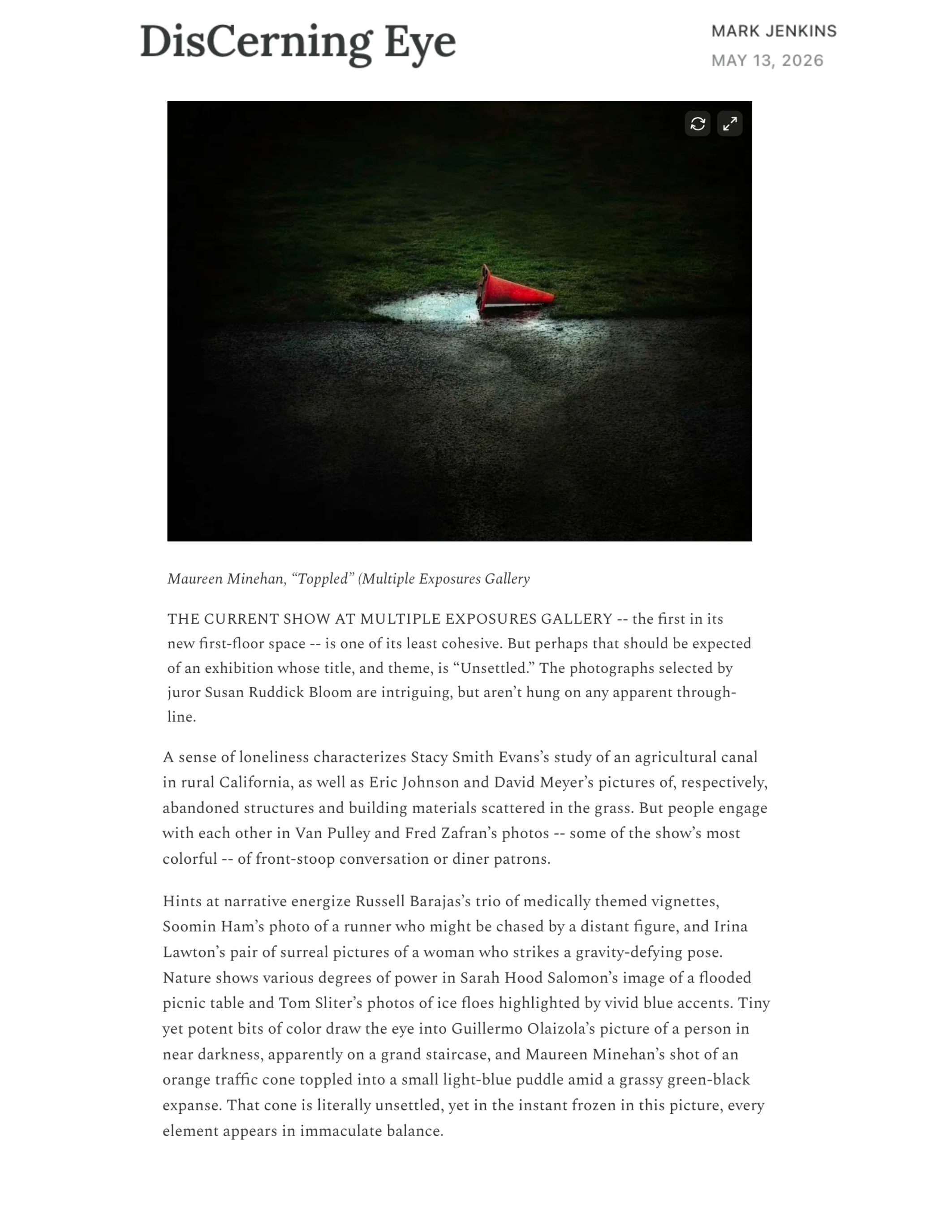 fine art photography by maureen minehan of an orange traffic cone overturned next to a puddle of blue-hued water and vibrant green grass
