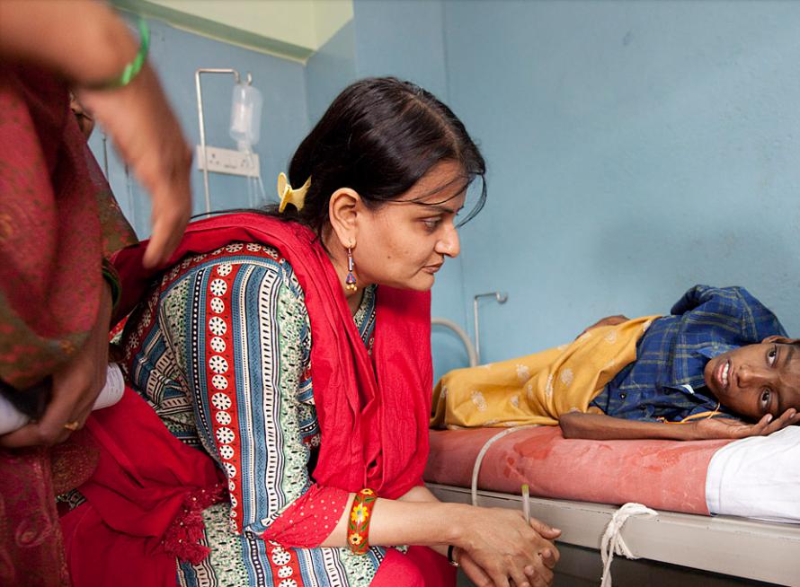 Dr. Gayatri Palat, director of palliative care, talks with Suresh during her rounds of the paediatric ward.