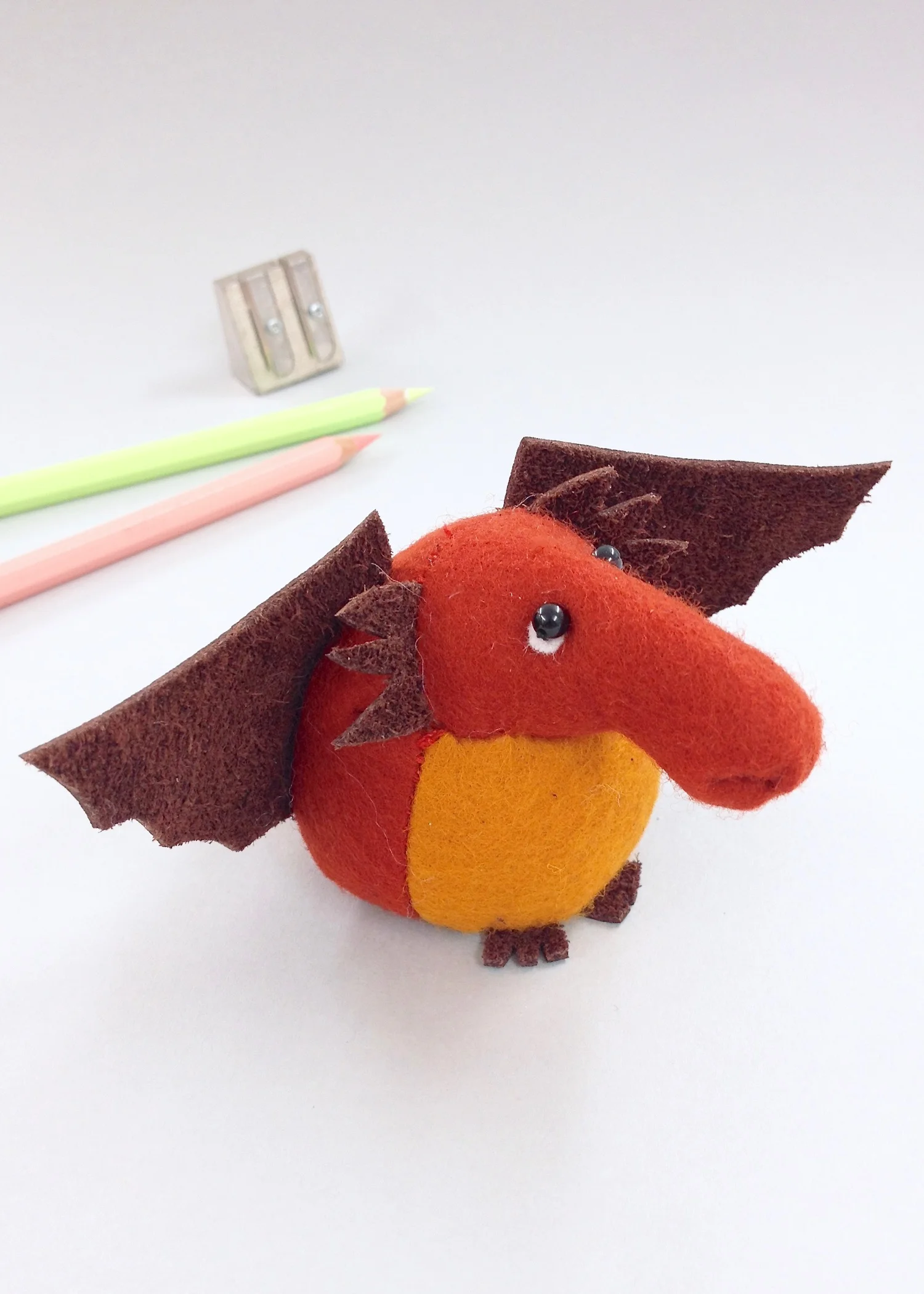 Bilberry Woods character David the Dragon as a cute felt paperweight with leather wings by Laura Mirjami | Mirjami Design.