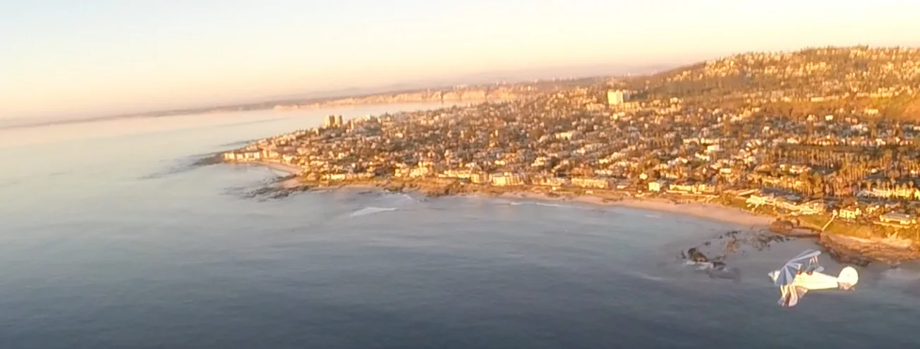 Flying north towards La Jolla Cove along the beach