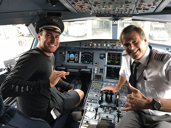 John Wade showing a potential pilot a high tech cockpit.