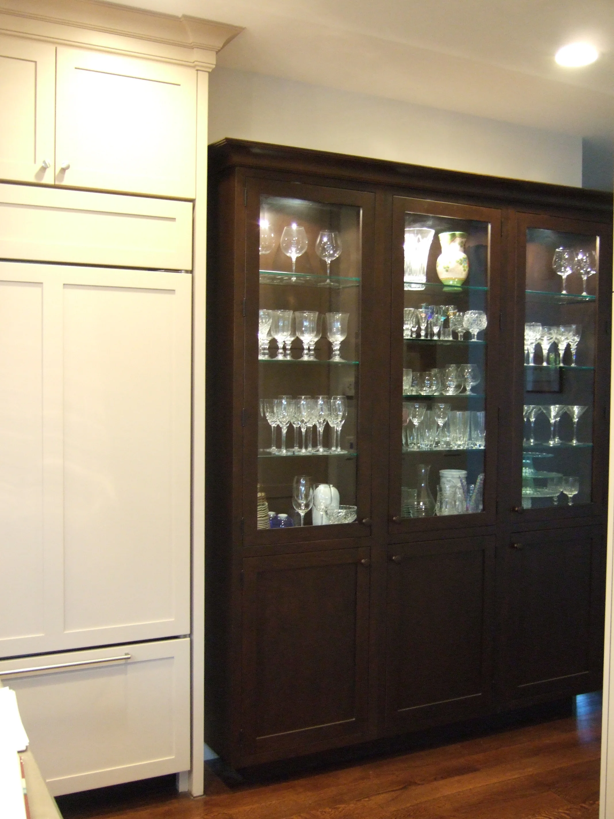 Old Greenwich Sophisticated Kitchen white and natural wood paneled cabinets lighted glass shelves