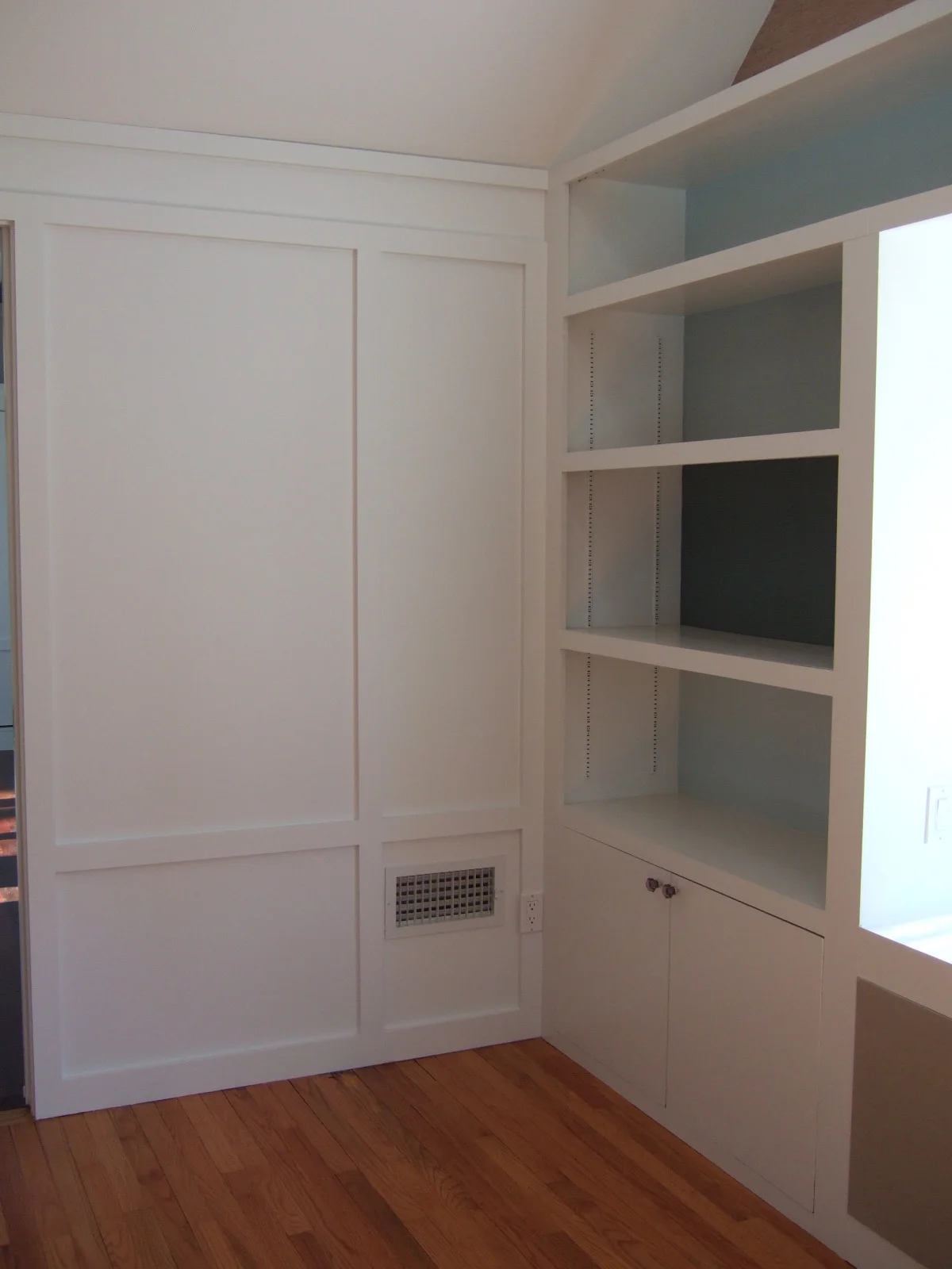 white paneled built in shelving and cabinets