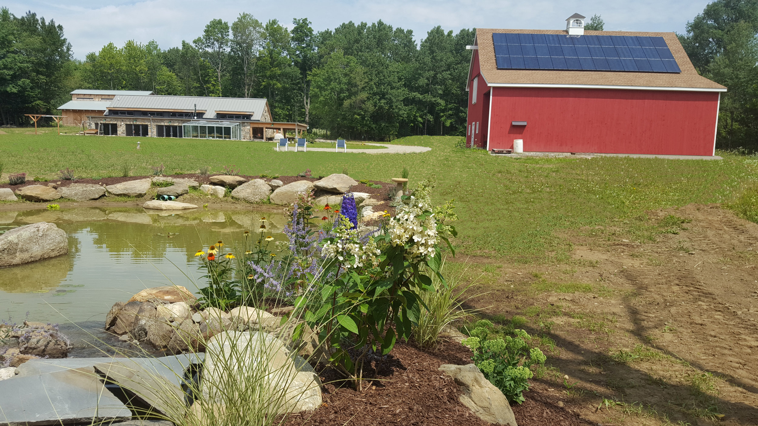 pond with house and solar panels on barn.jpg