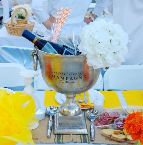 Details: The glorious champagne bucket with plastic silver stemmed flutes and striped orange straws. 💛