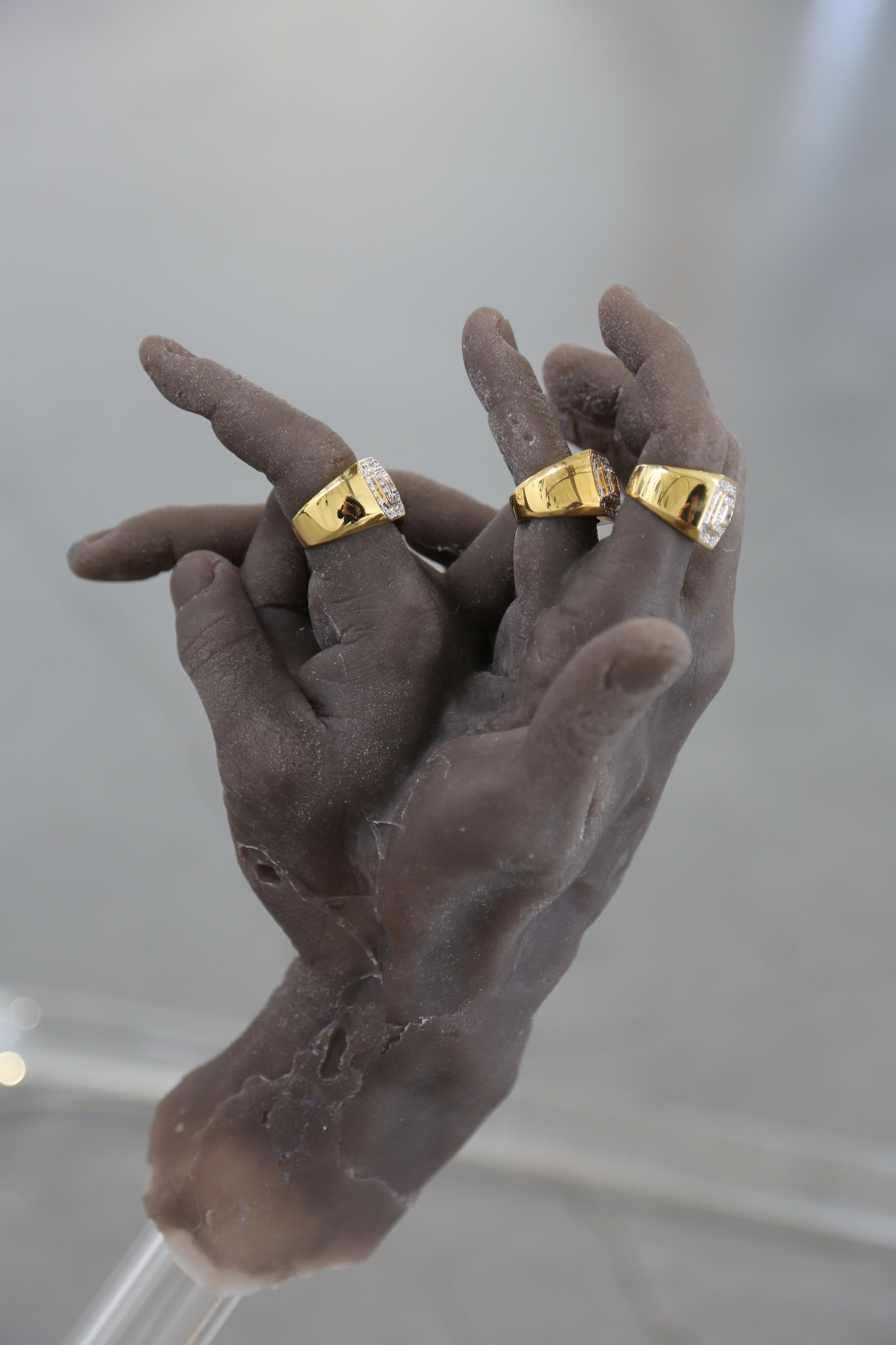   that hand gon’ stutter,  2019  silicone, glass, Patek water, gold alloy 