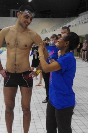 Jean interviews another swimmer poolside.