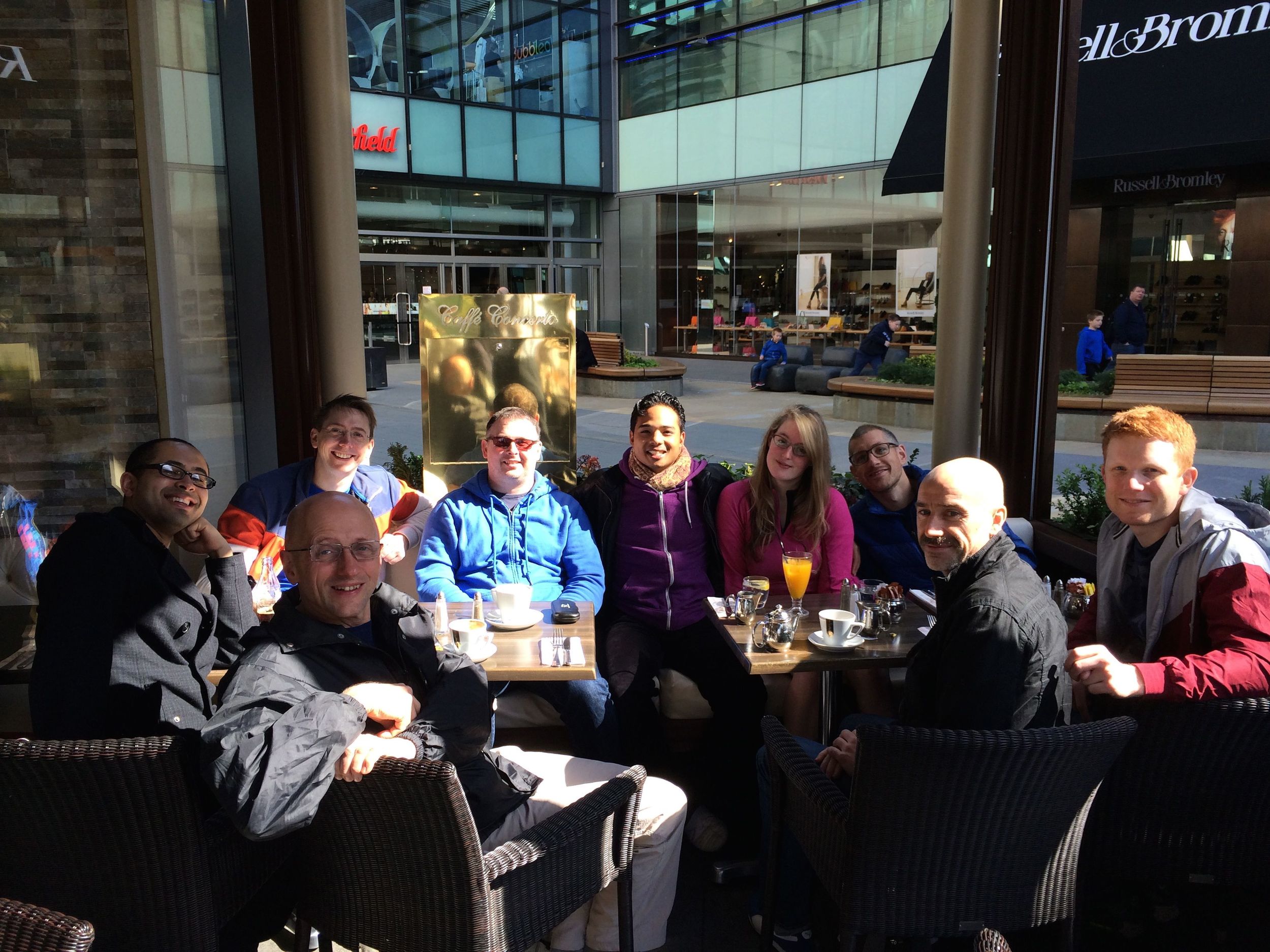 A group of happy swimmers having breakfast.
