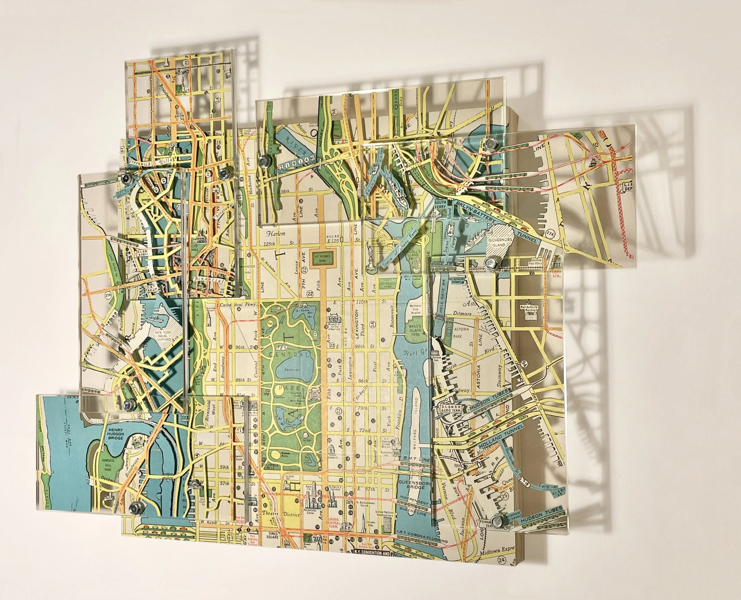 Building a City, Block by Block,, 2026, Hand Cut Map, Acrylic, Metal on Panel, 12H x 15W