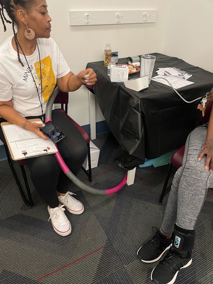 Sisters Together: Dannielle conducting a BP screening