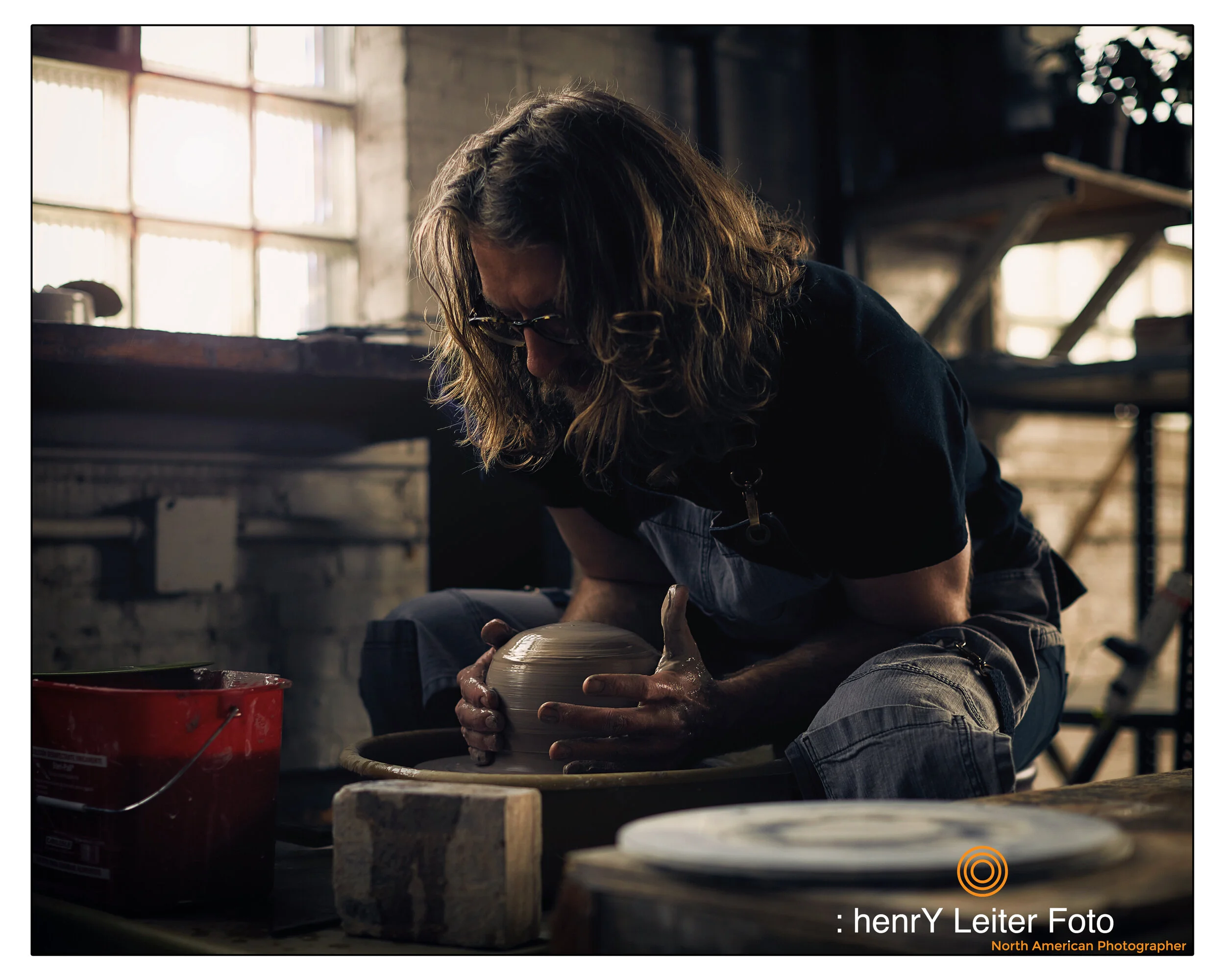 Portrait of the ceramic artist in his studio, by photographer henrY Leiter.
