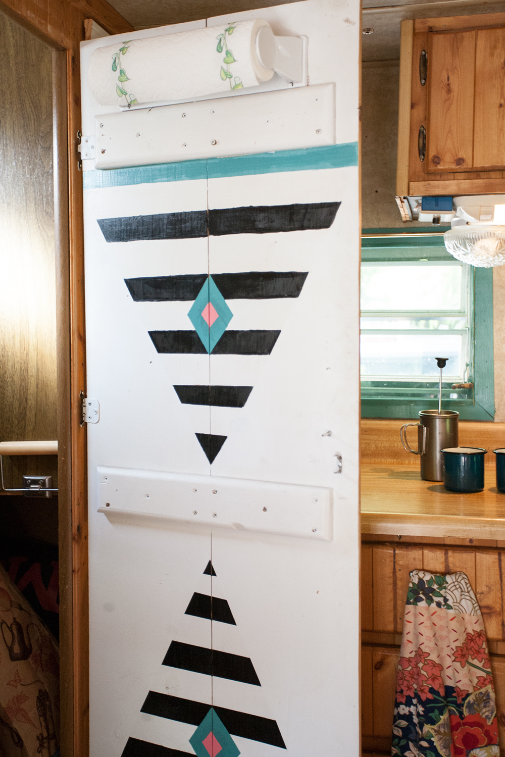 Other than adding the wallpaper on the back wall (which was a bitch, I don't know how 90's Moms did it!?), we wanted to preserve the beautiful woodwork throughout the interior. I only painted the window trims and the inside of the closet door for a fun pop of design while Adam took care of all the rewiring and gas lines. We chose minimal art for the walls because we love the simple aesthetic of the original wood. 