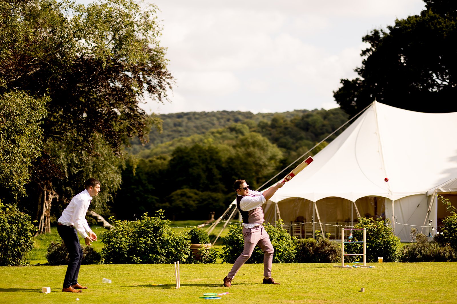 Wedding guests playing cricket