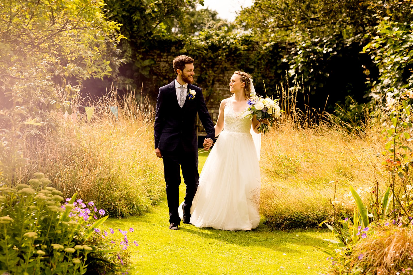 Bride and groom walking in Walled garden