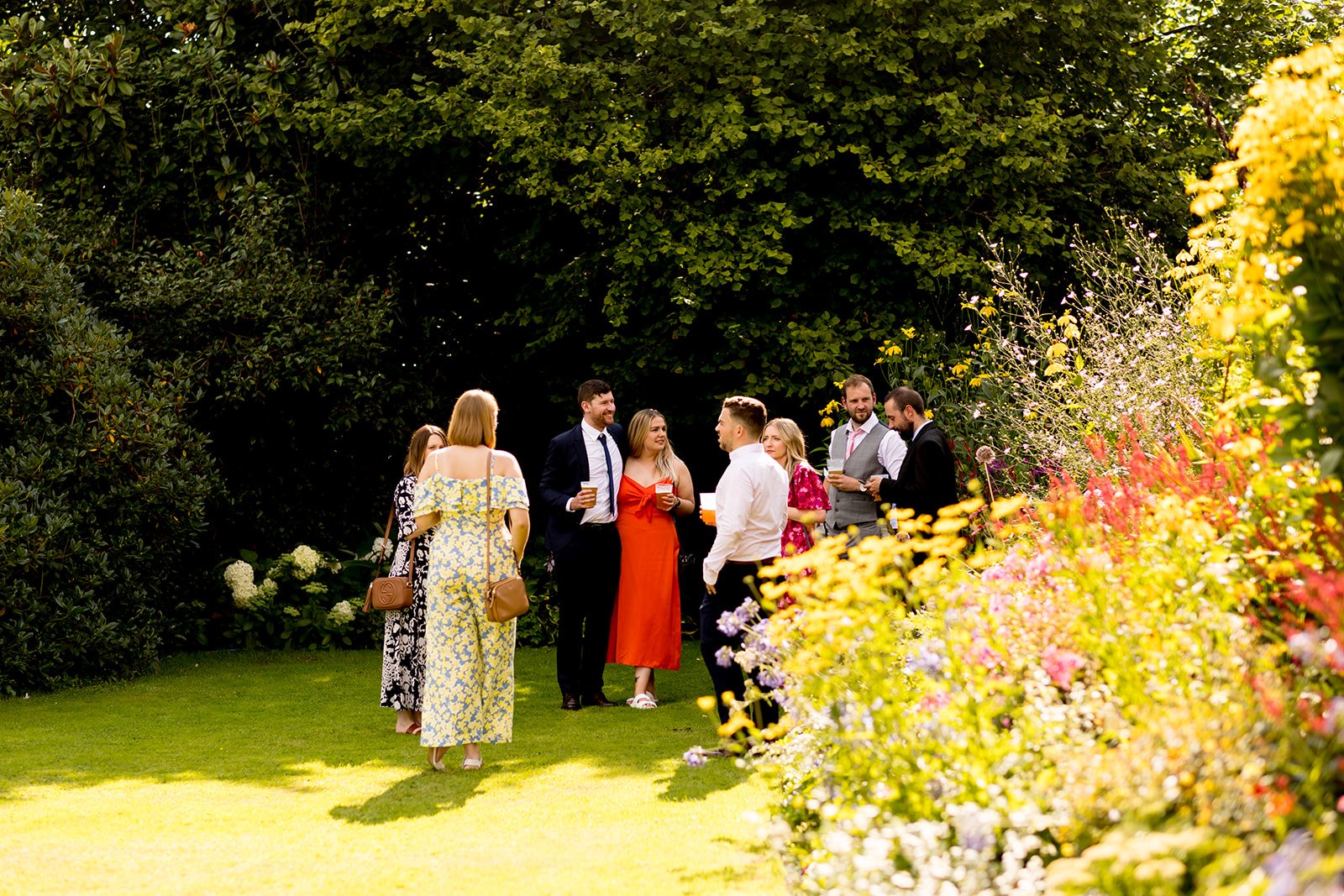 Wedding guests relaxing in the shade