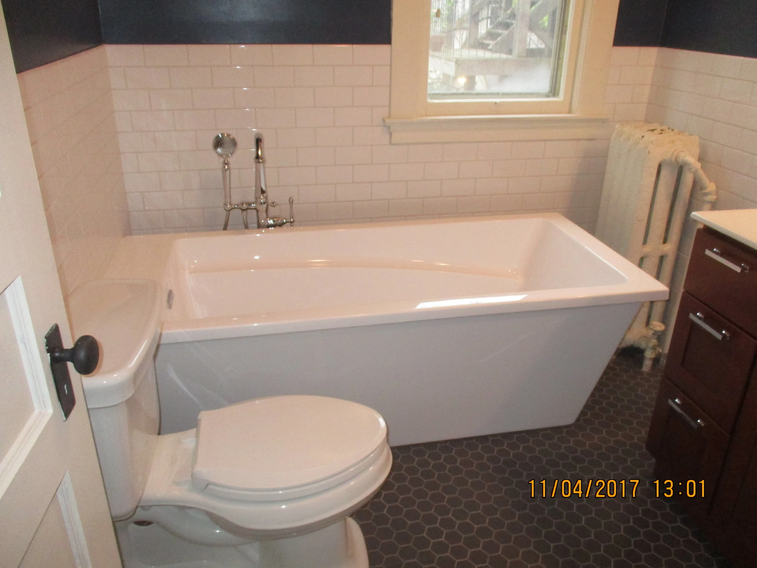 New freestanding tub, hexagon tile floor and brick style wall tile