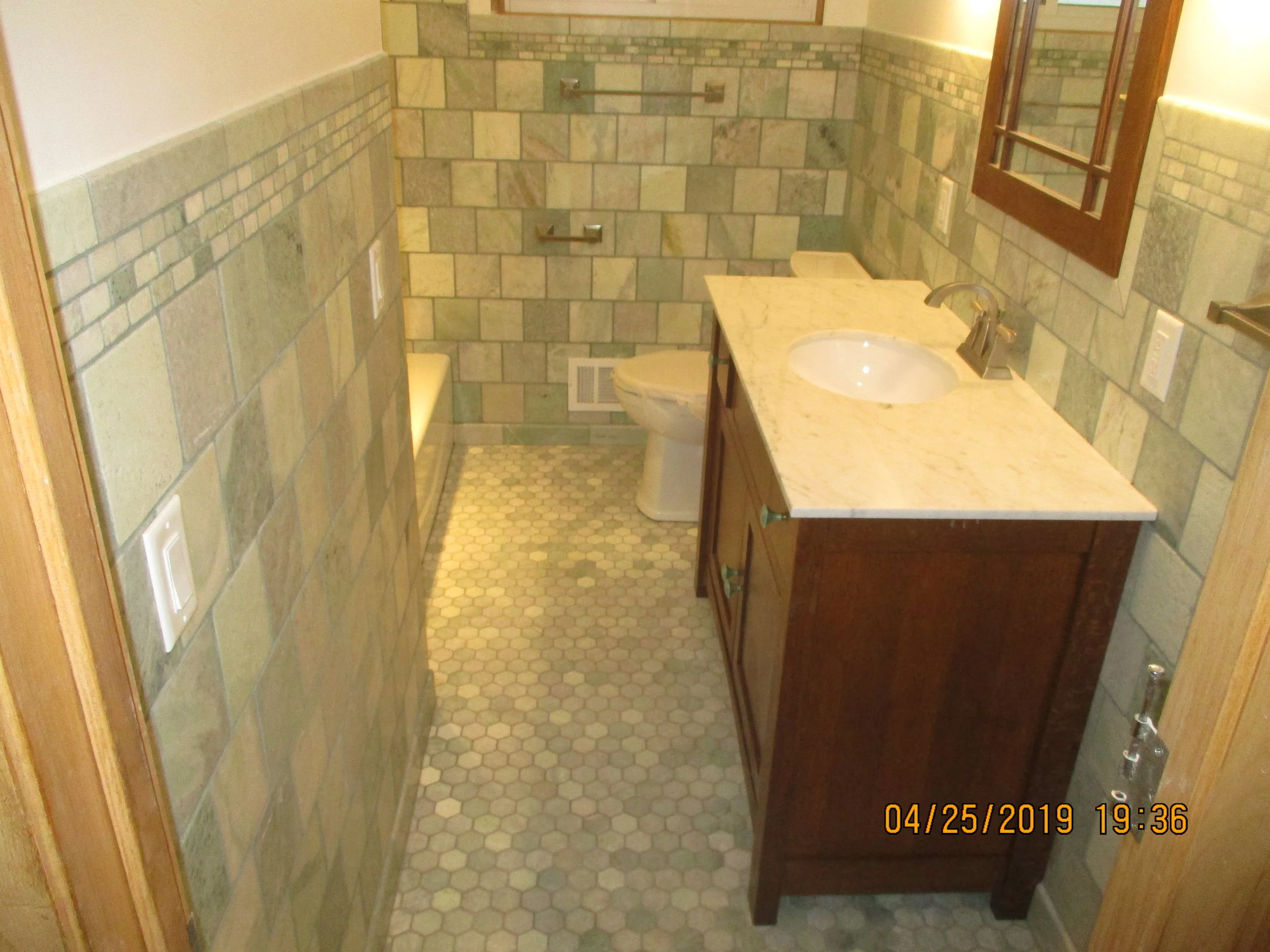 New green marble on the walls and the floor, new vanity