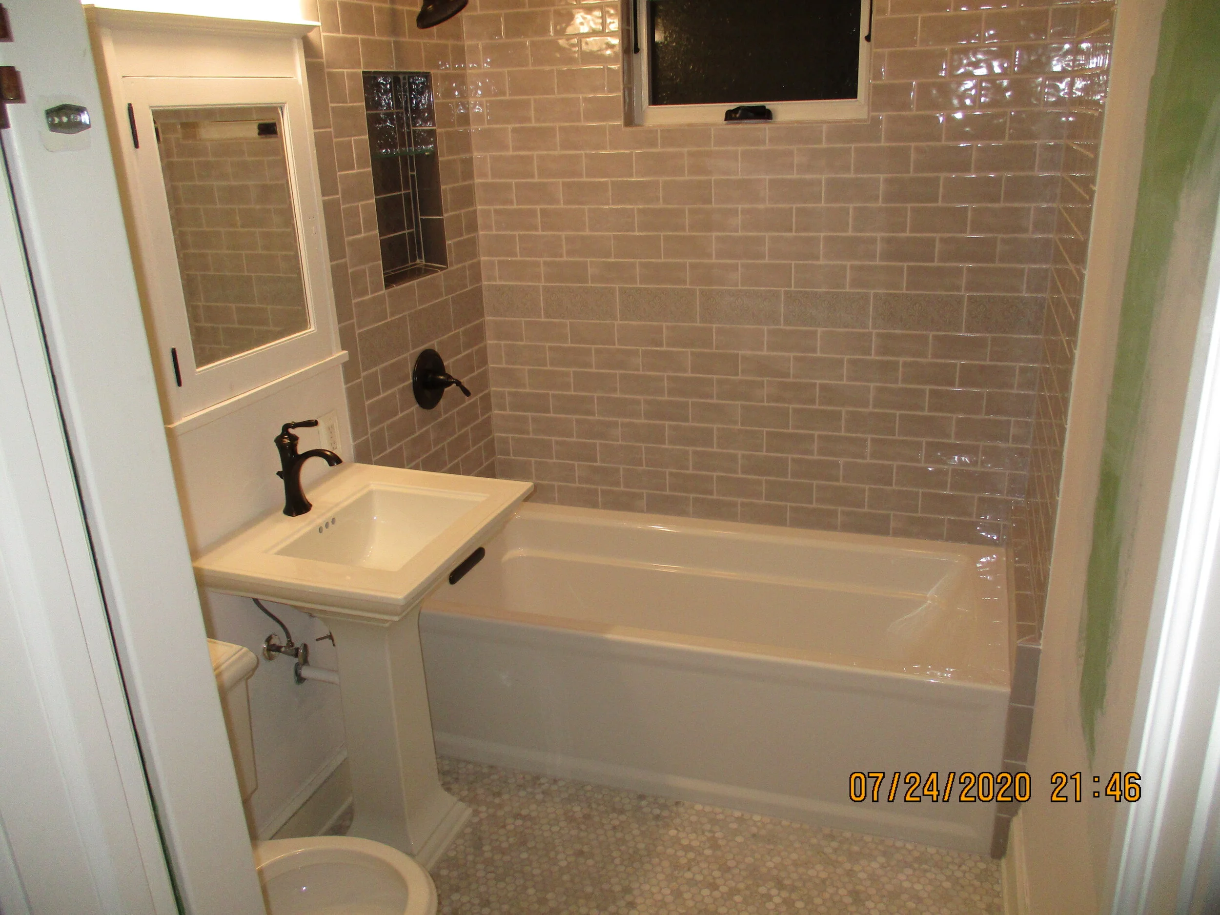 AFTER: New 2020's style, new window, tub, floor and vanity.