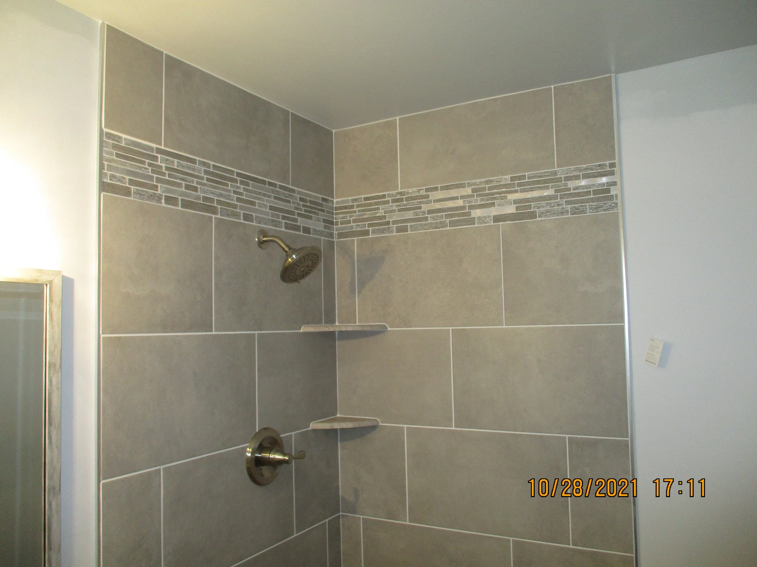Before: Corner shower with 1980's style tile
