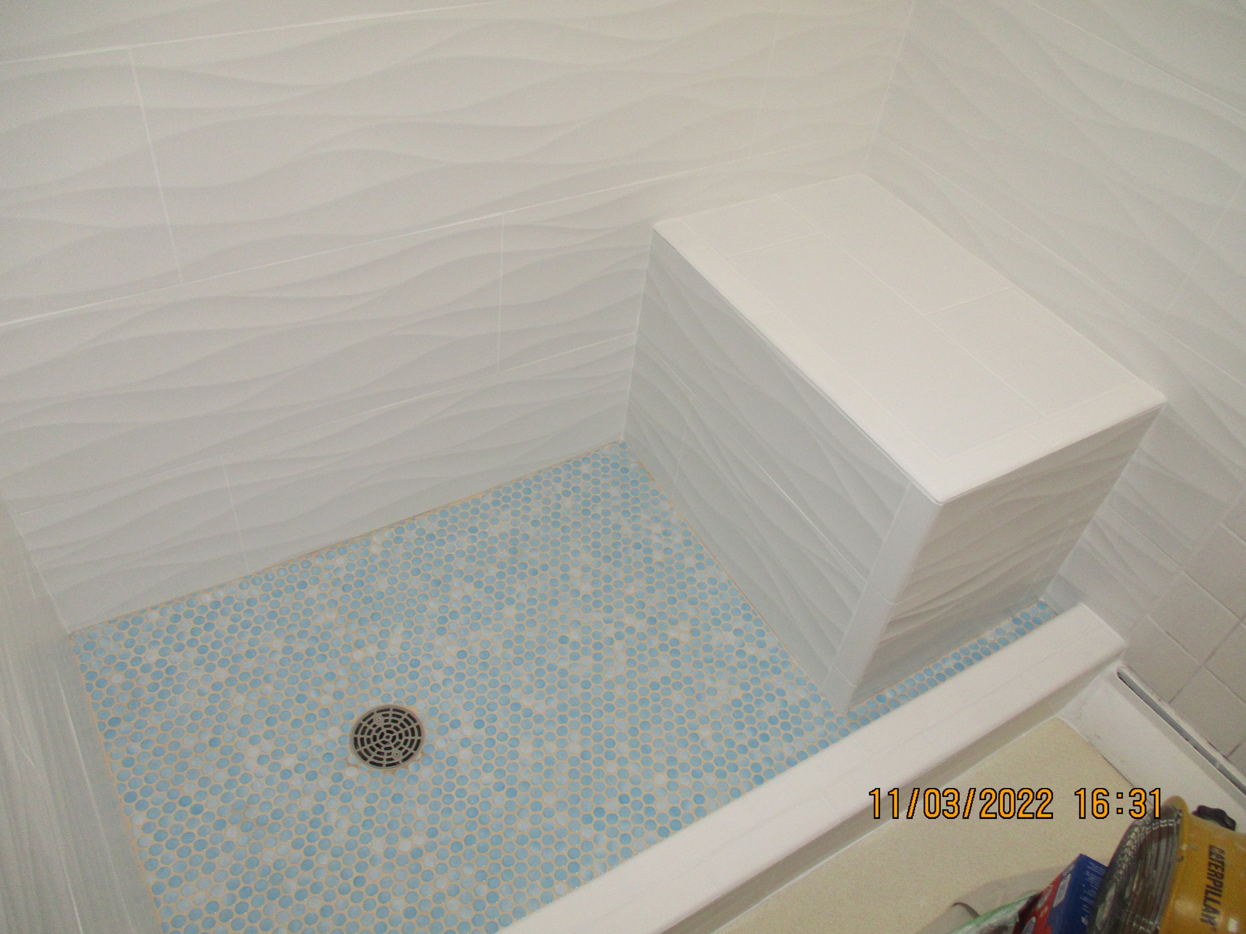 New custom shower pan, bench and embossed wall tile with waves style