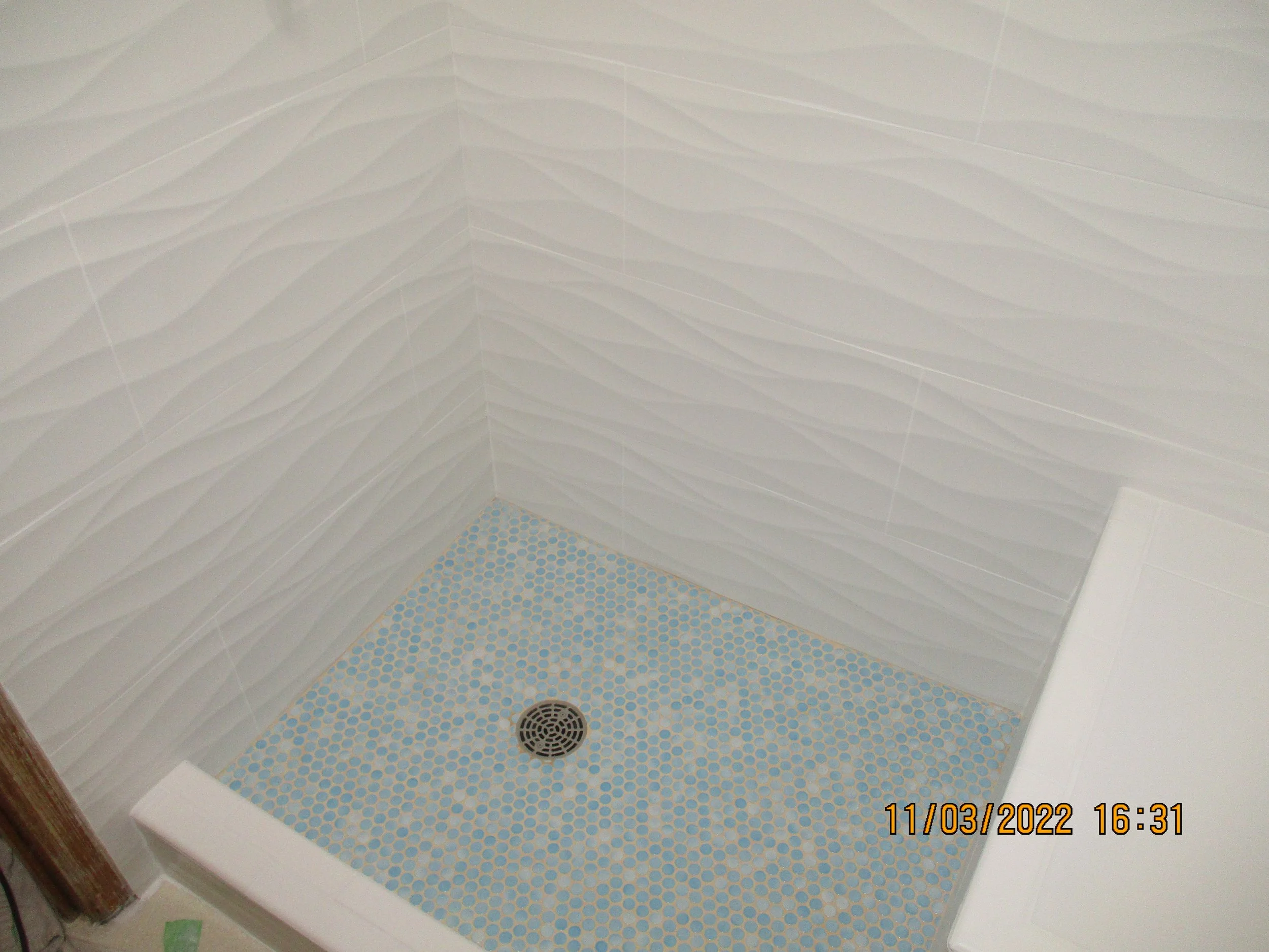 New custom shower pan and embossed wall tile with waves design
