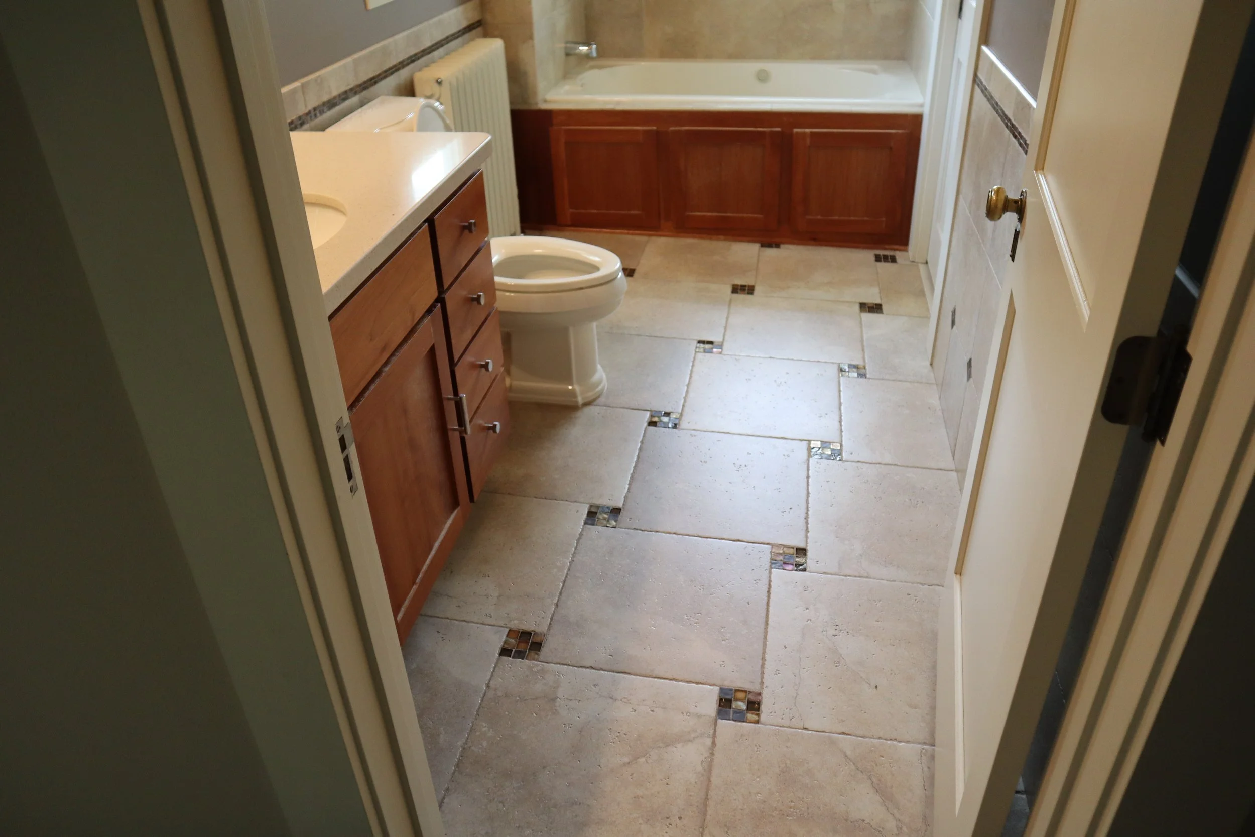 Before: tall whirlpool and 1990s style tile work
