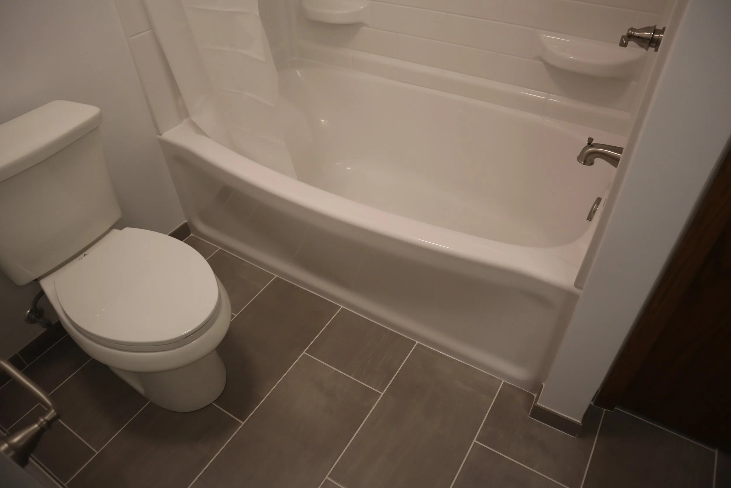 After: porcelain tile floor, fiberglass tub with 3-piece wall surround unit