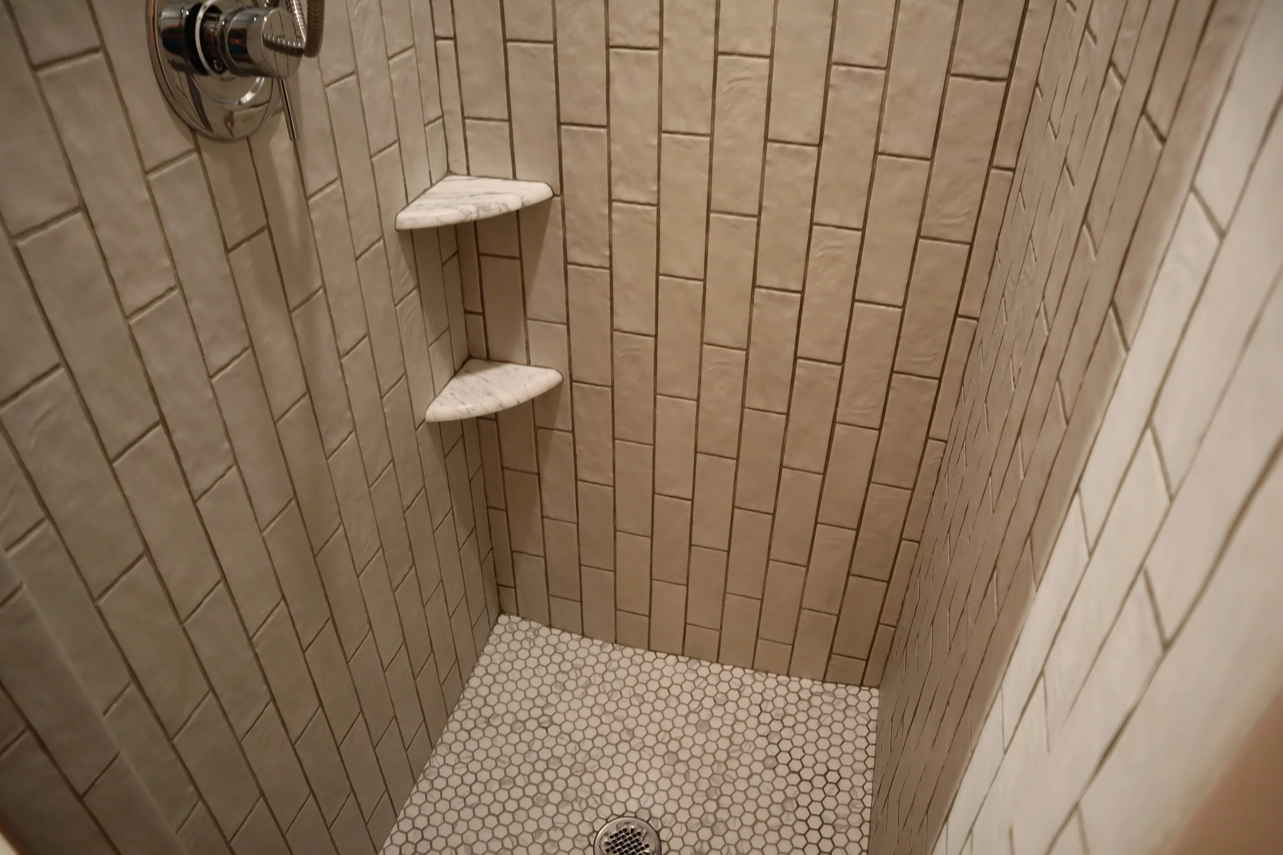 After: 2023 custom shower pan and new wall tile