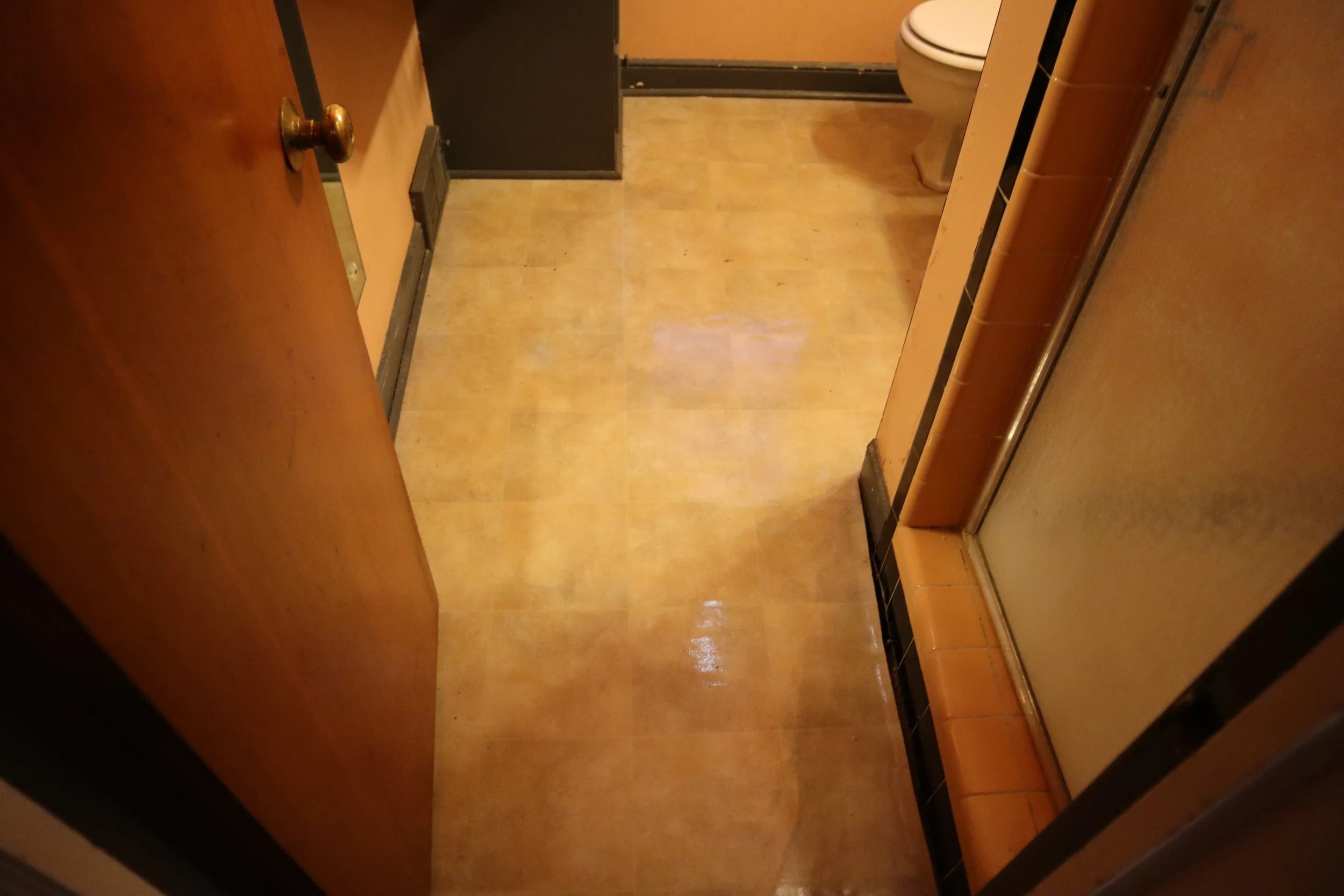 Before: 1980's linoleum floor and wood baseboard