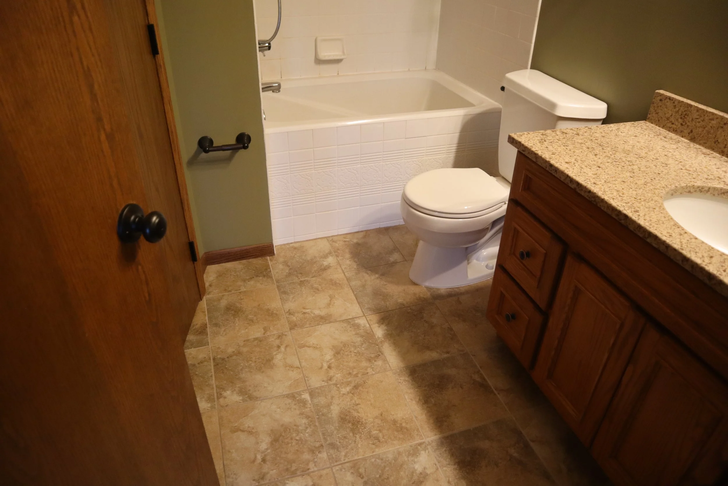 Before- 4" x 4" wall tile on the front of the tub skirt