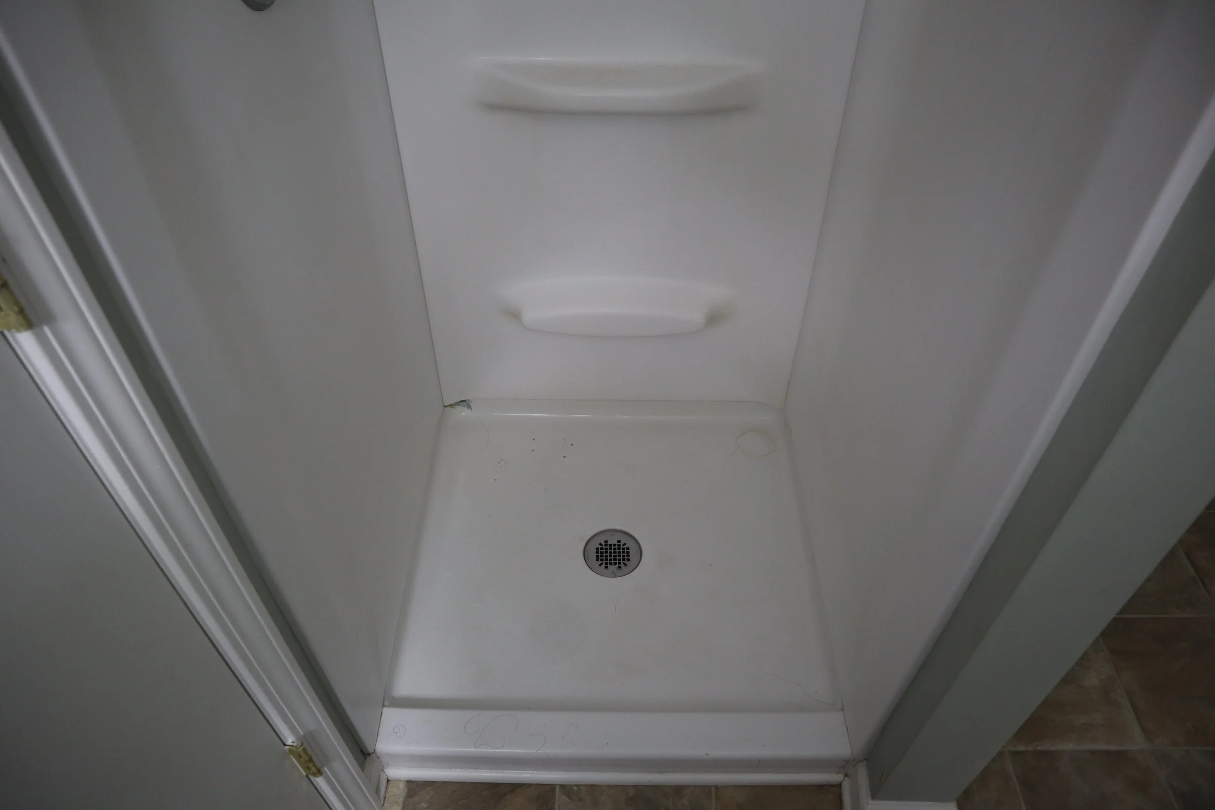 Before- 1990's Style fiberglass shower pan and fiberglass walls