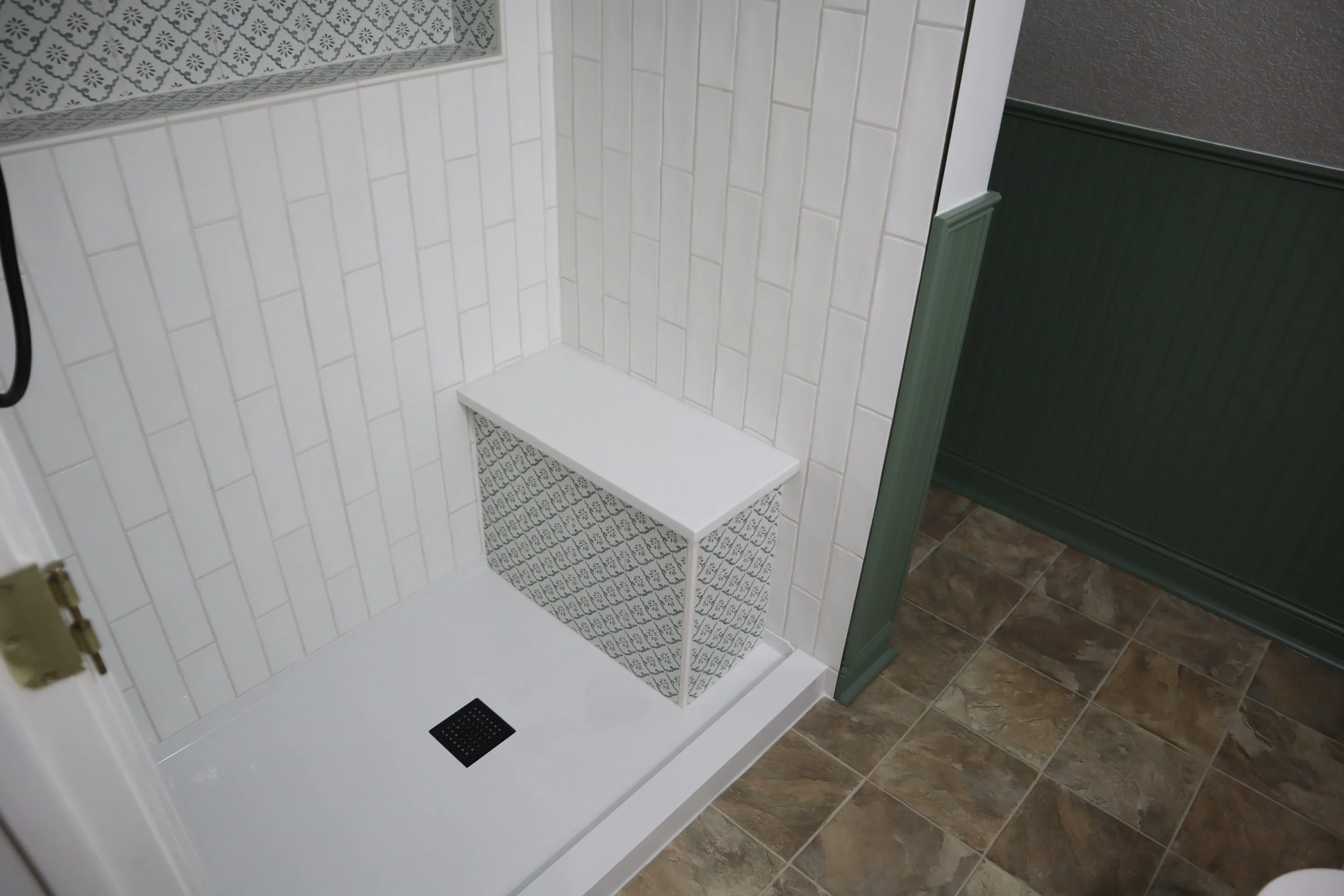 After- 2025 shower with custom bench. Natural stone top on the bench