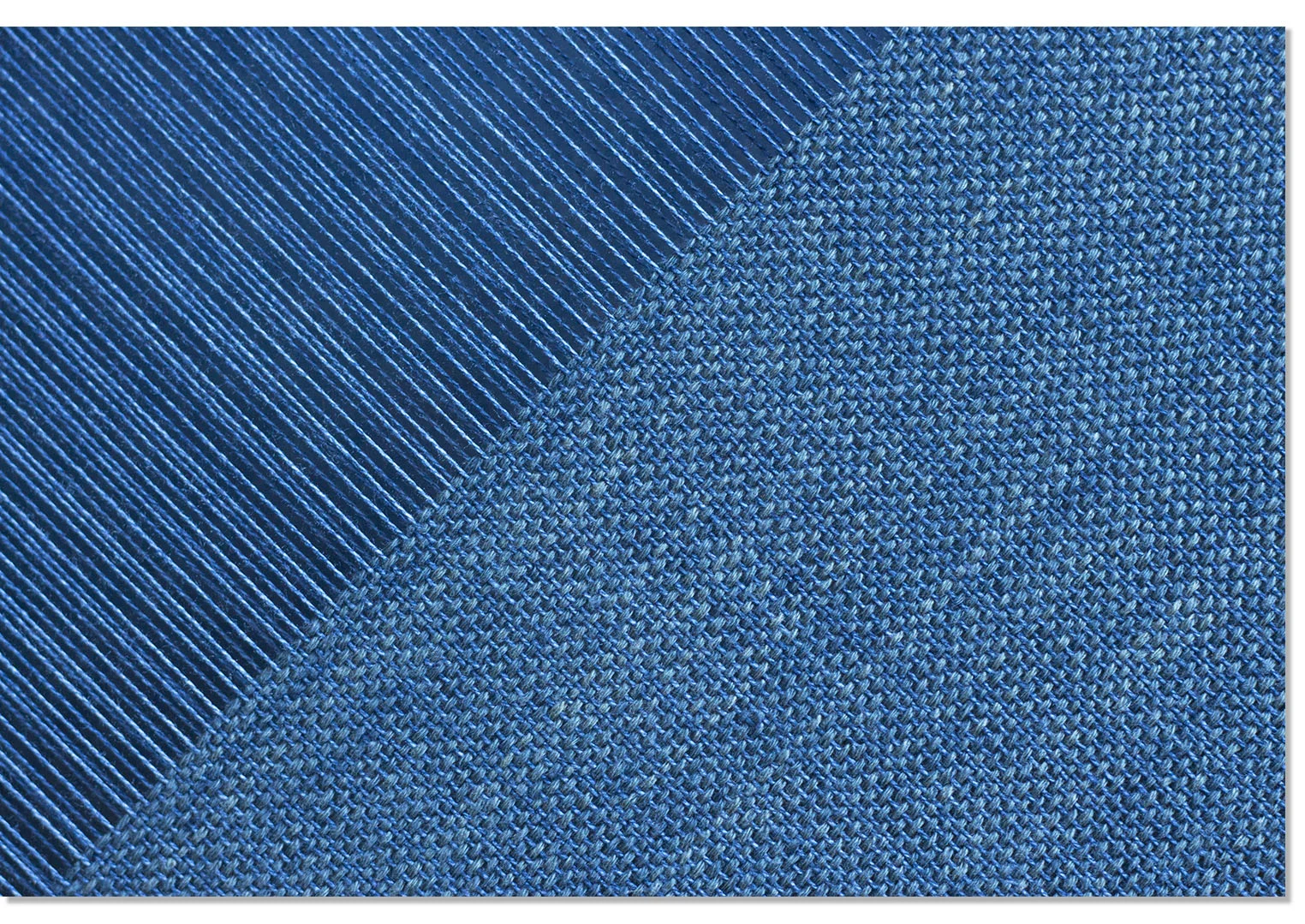 Knit sweater, unravelled, dyed with indigo & being woven on the loom