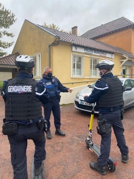 Two French Police Officers on Electric Scooters Outside the Police Station