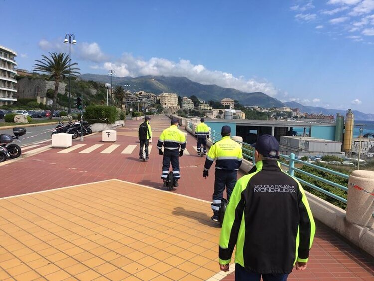 Five Members of the Genoa COVID Protection Team Riding their Electric Unicycles on The Promenade.