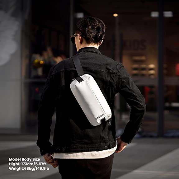 Person walking wearing a white tomtoc 8 inch Explorer sling bag on their back.jpg.jpg