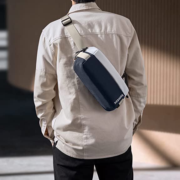 Person walking wearing a blue tomtoc 8 inch Explorer sling bag on their back.jpg.jpg