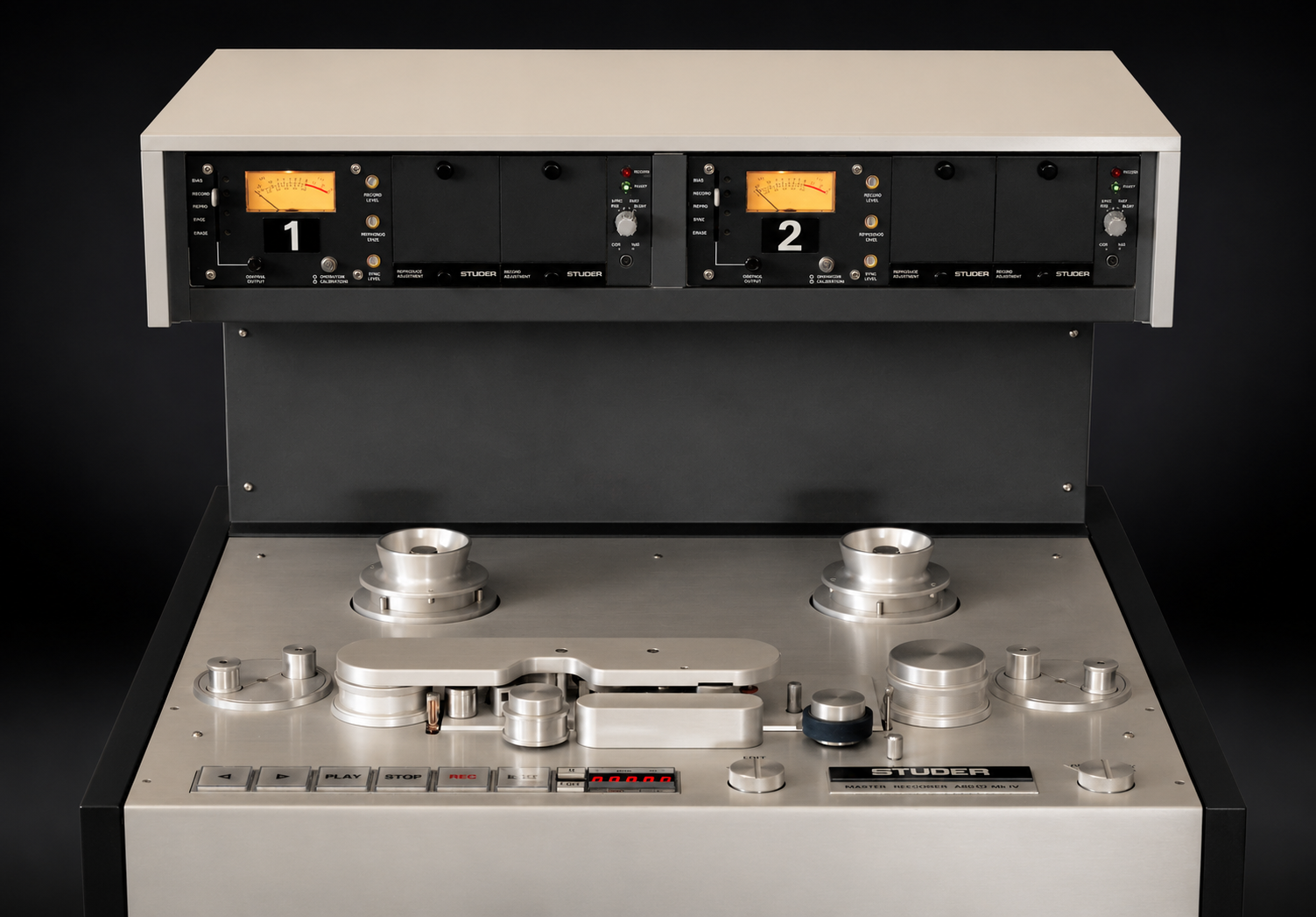 A Studer A80 open-reel master tape recorder, showing the full silver metal transport deck and the overhead bridge with two VU meters labeled 1 and 2.