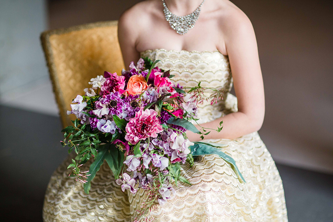  Cascading bridal bouquet with purple Japanese scabiosa, purple hellebores, Silvery Moon Japanese sweet pea, Charlotte ranunculus, peach ranunculus, jasmine vine and blue star fern, accented with vintage velvet and grosgrain cascading ribbons. Image 