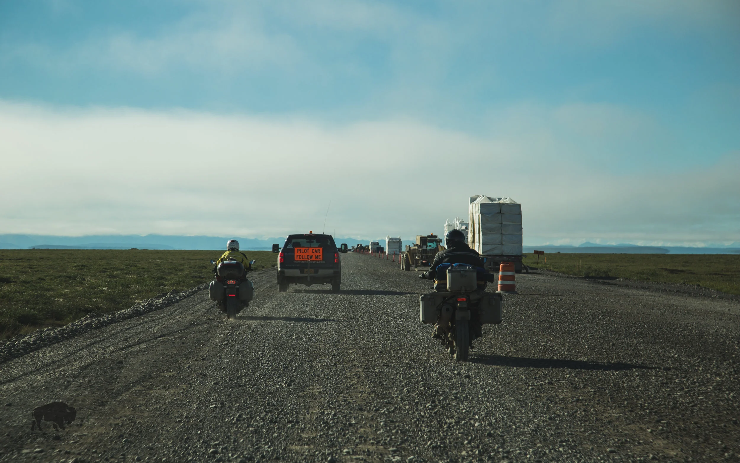 Driving South on the 56 mile stretch of construction. Those big blocks of white are stacks of styrofoam which are laid underneath the gravel to insulate the permafrost from the sun so that it doesn't melt causing road damage.