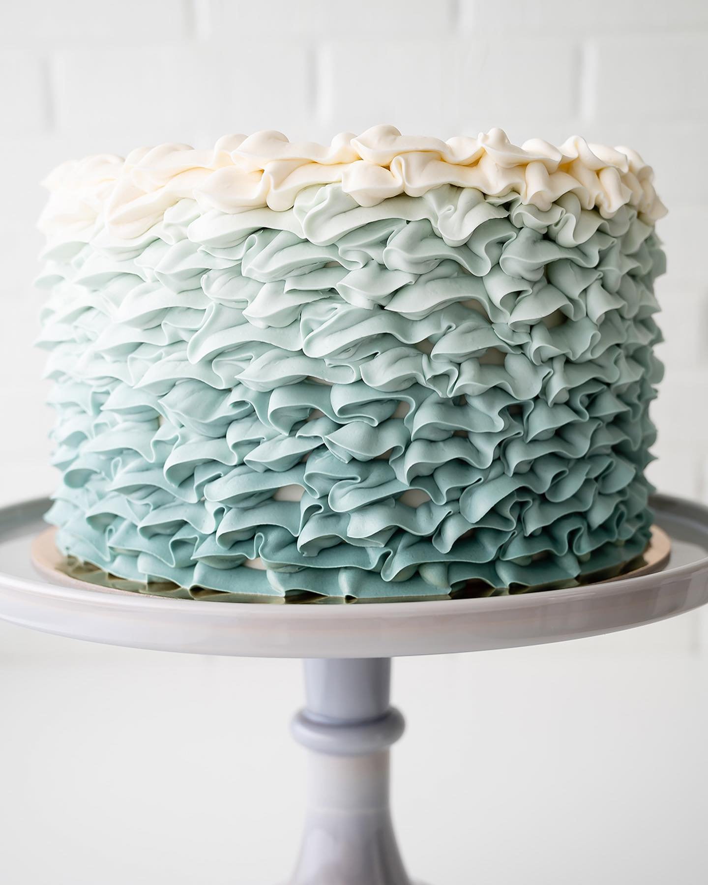 8&rdquo; Ruffle Cake in Sage-to-White ombr&eacute; with Sage icing message 🌿🤍🎂 Customize your next Made-to-Order Cake and submit a preorder request at the bio link.