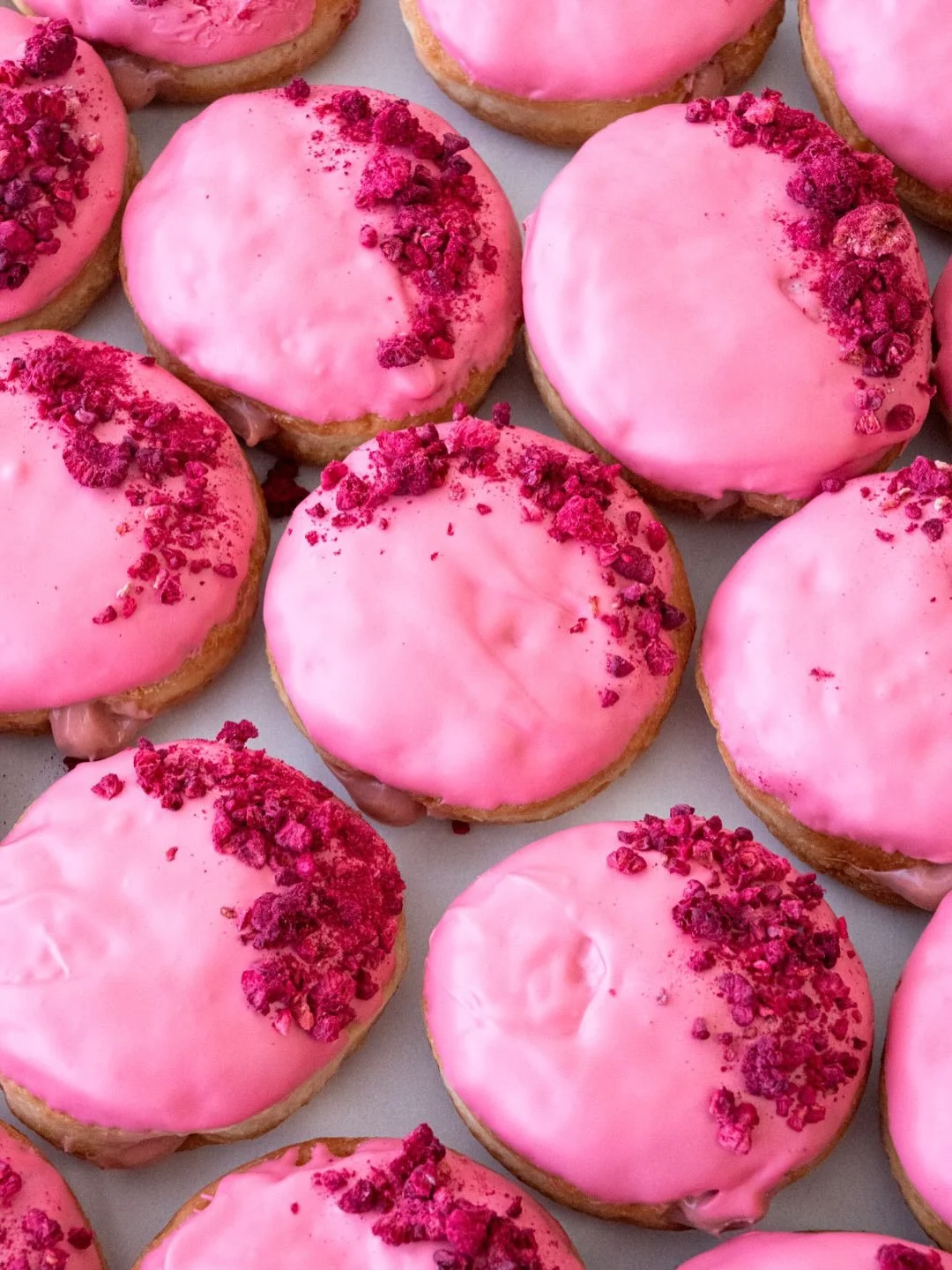 We&rsquo;re still crushing on Raspberry Cream 💕☁️🍩 Fluffy yeast doughnuts stuffed with raspberry pastry cream, dipped in pink candy and sprinkled with freeze-dried raspberries. Here and @suarezbakeryandbarra till sold out only for a limited time, b