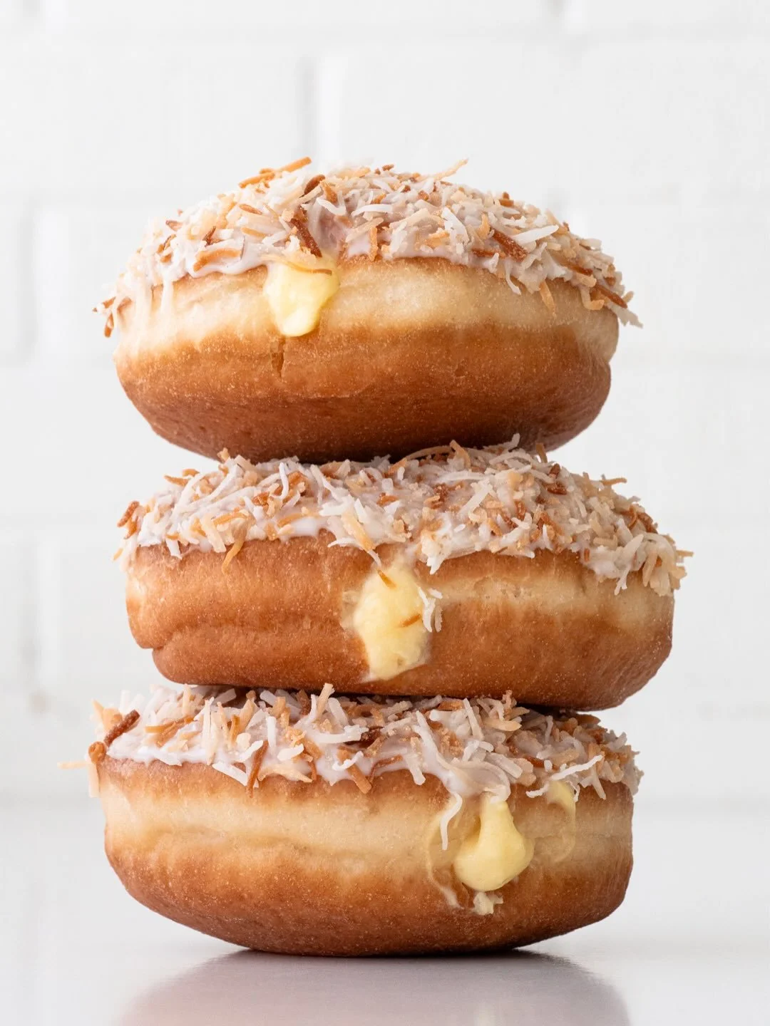 Just a gentle reminder that Toasted Coconut Doughnuts are still here being fluffy, coconut pudding-filled, coconut milk-glazed, and covered in toasted coconut, but they&rsquo;re not waiting for you forever 🥥🌴🍩 Here and @suarezbakeryandbarra till s